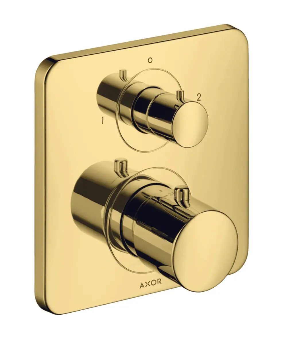 Thermostatbedienung in glänzendem Gold mit zwei Drehknöpfen für Temperatur- und Umschaltung, gefertigt von AXOR. Wandmontage sichtbar auf quadratischer Grundplatte.
